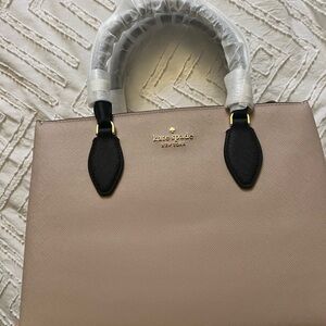 kate spade blush satchel with black trim and gold logo